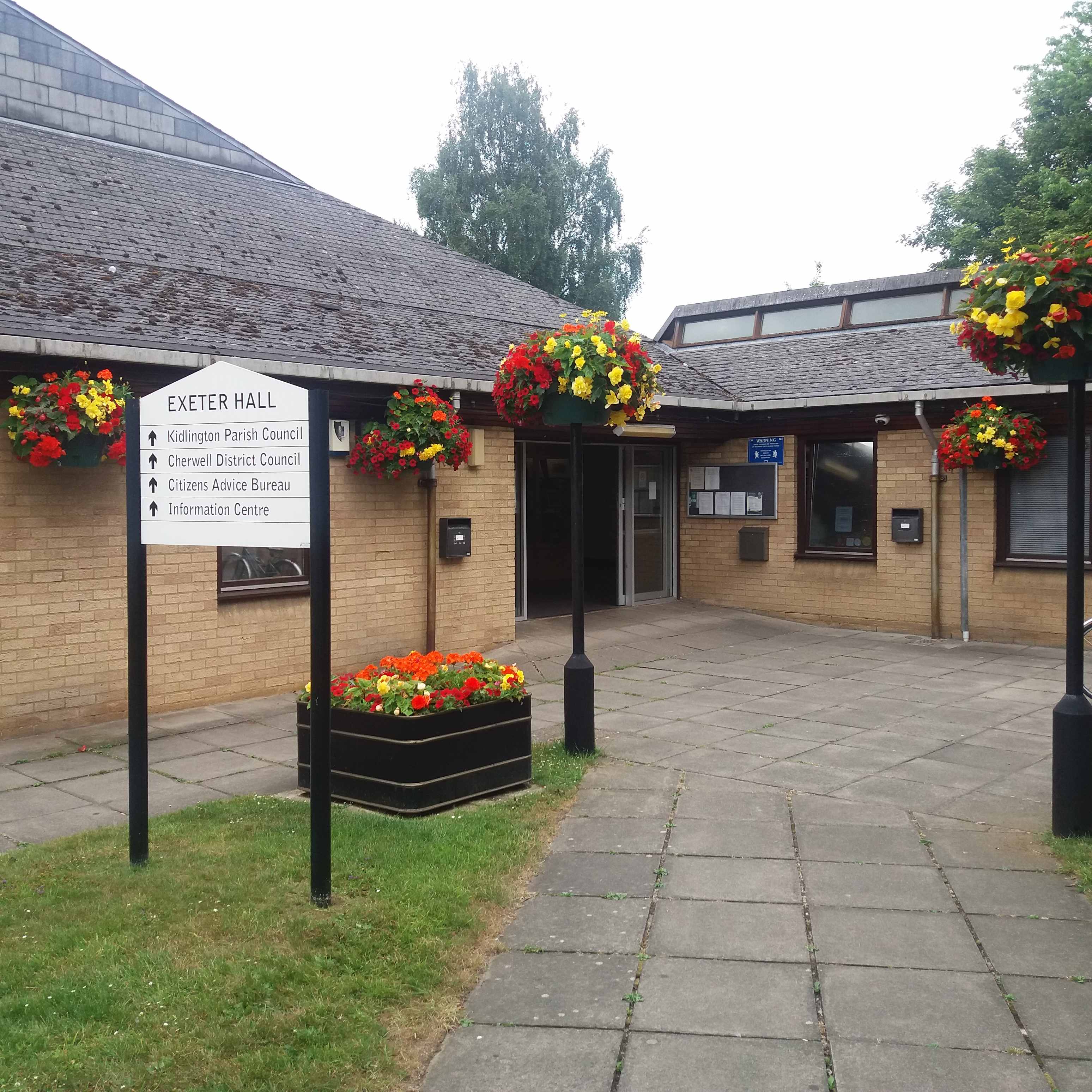 exeter hall with red and yellow flowers